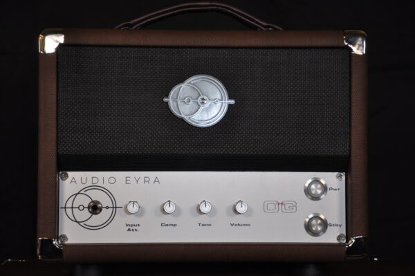 A silver and black amplifier sitting next to each other.