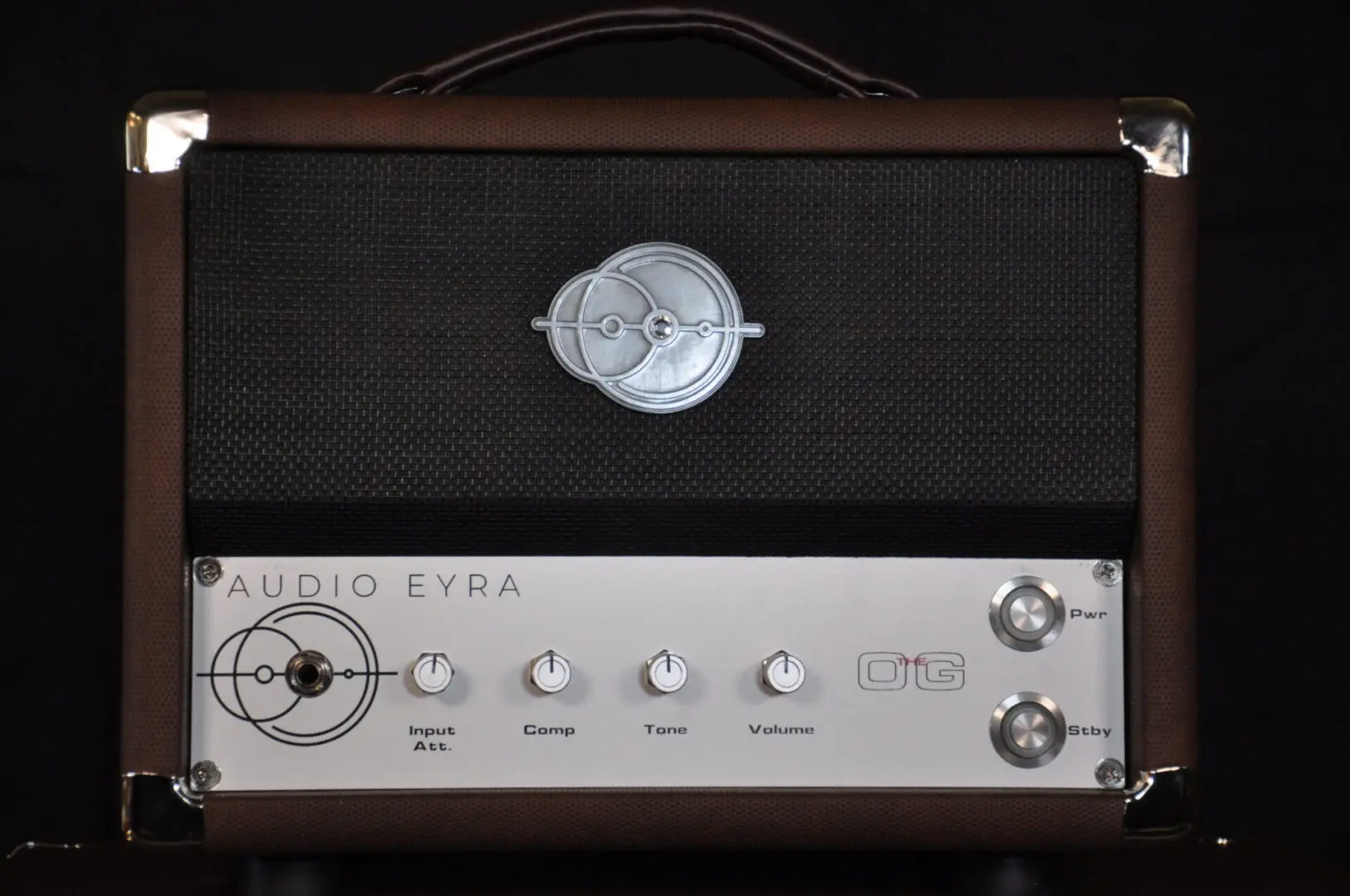 A silver and black amplifier sitting next to each other.