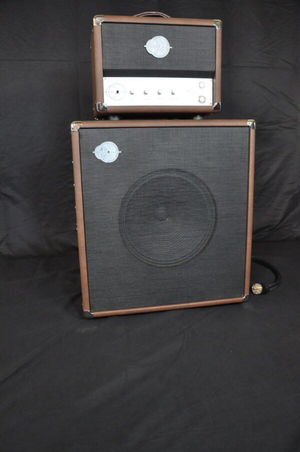 A brown and black guitar amp sitting on top of a table.