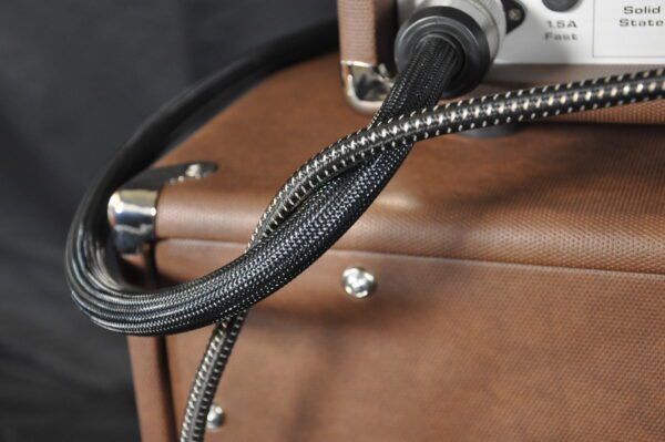 A close up of the power cord on a suitcase